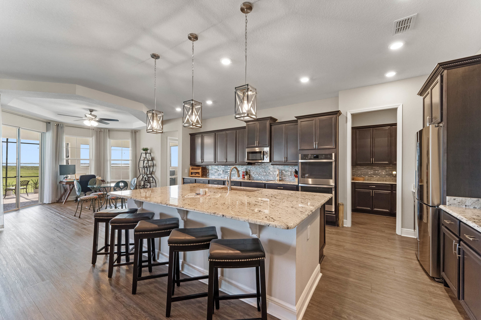 large kitchen with dark cabinets and breakfast nook
